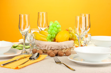 Table setting in green and yellow tones on color  background