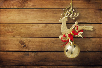 Christmas golden deer ornament on wooden background