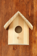 Obraz na płótnie Canvas Nesting box na drewnianym tle