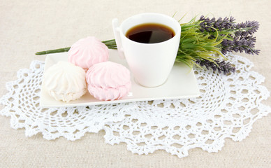 Marshmallows on plate on light background