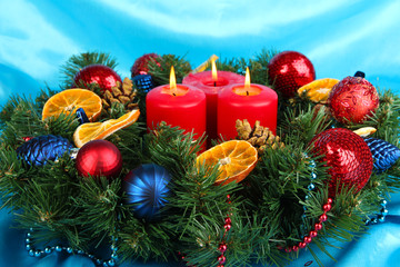 Beautiful Christmas wreath on blue fabric background