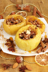 Baked apples on plate on wooden table