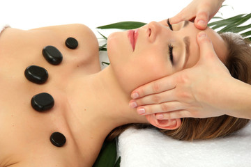Obraz na płótnie Canvas Portrait of beautiful woman with spa stones taking head massage