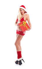 A young woman in erotic Christmas clothes holding a present
