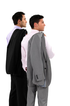 Two businessmen with their jackets over their shoulders