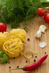 Ingredients for Italian cooking on wood background