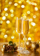 Two glasses of champagne with a Christmas decor .