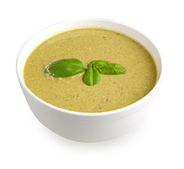 basil cream soup in a bowl isolated on white