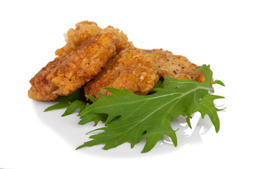 Breaded chicken sticks with mitsuna salad leaves on white