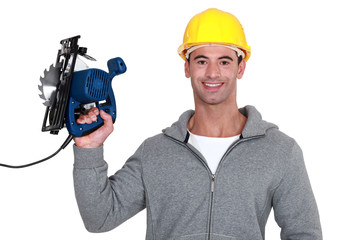 craftsman holding an electric saw