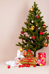 Baby under christmas pine