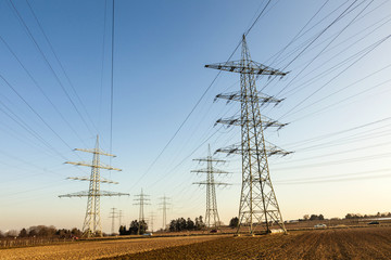 hight voltage tower in rural landscape with blue sky