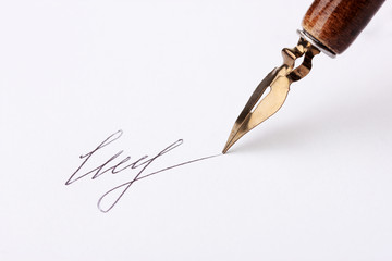 Closeup of signature (fake, not real) and ink pen, isolated
