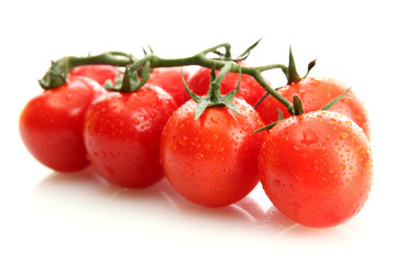 cherry tomatoes on a branch with drops isolated on white
