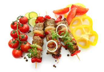 tasty grilled meat and vegetables on skewers, isolated on white