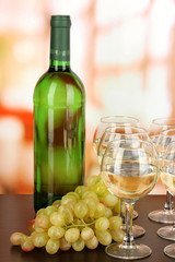 White wine in glass and bottle on room background