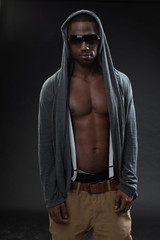 Fototapeta na wymiar Black fitness man urban style with dark sunglasses. Studio shot.