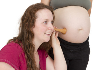midwife listening at human belly