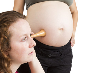 midwife listening at human belly