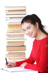 Happy smiling young student woman with books