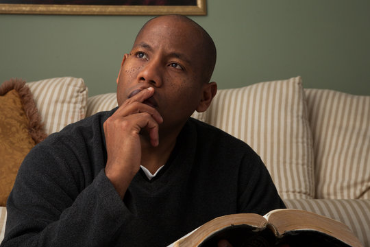 African American Studying The Bible At Home