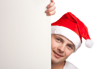 Man with santa hat peeking out of blank poster