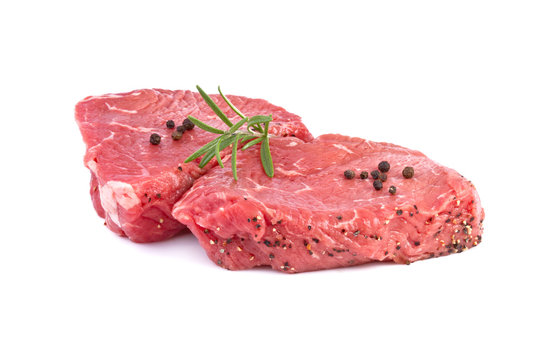 raw beef steak with green herbs