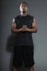 Tough and cool black american basketball player. Studio shot.