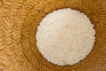 Raw rice in a bamboo basket.
