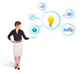 Young woman presenting light bulb with colorful graphs and diagr