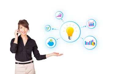 Young woman presenting light bulb with colorful graphs and diagr
