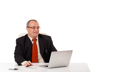 buisnessman sitting at desk and looking laptop with copy space
