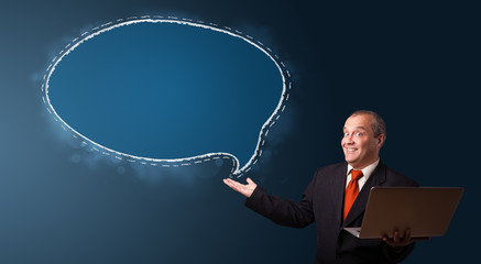 funny businessman holding a laptop and presenting speech bubble