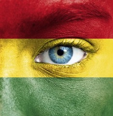 Human face painted with flag of Bolivia
