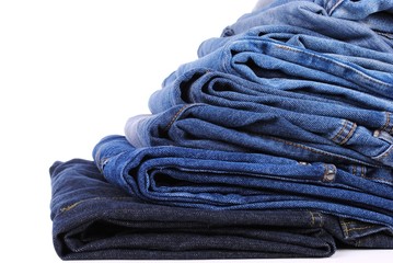 stack of different kind of blue jeans, on white background