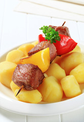 Grilled meat skewer and potatoes