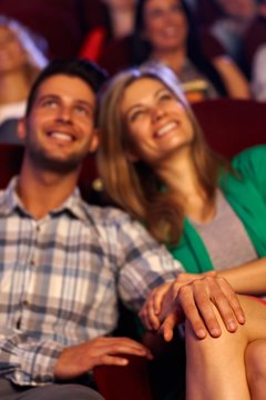 Happy romantic young couple in cinema
