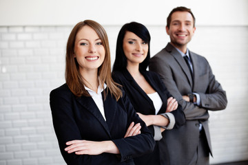 Three business people smiling