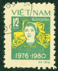 stamp printed in Vietnam shows woman with tractor