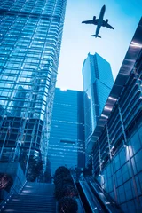 Foto op Canvas modern gebouw met vliegtuig in de schemering © chungking