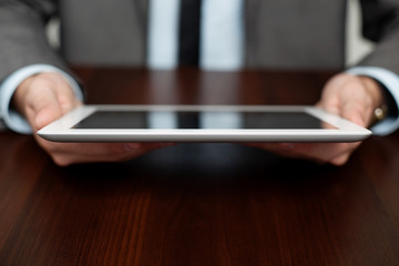 Fototapeta premium Businessman using digital tablet by the desk