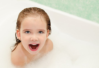 Cute little girl is taking a bath