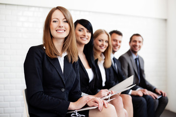 Successful businesswoman in group of people