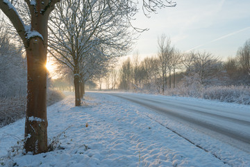 Snowy road at sunset