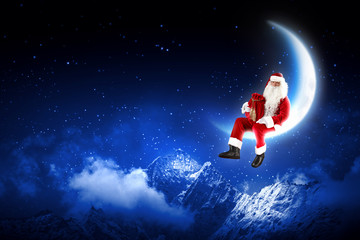 Obraz na płótnie Canvas Zdjęcie Santa Claus siedzi na księżycu