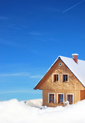wooden cottage in winter