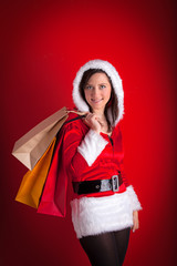 Beautiful girl wearing santa claus clothes with christmas gift