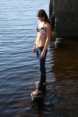 Fototapeta premium young woman posing on the waterfront