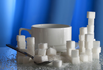 sugar cubes around the white cup (shallow dof)