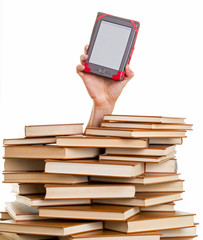 Hand holding an electronic book reader above books